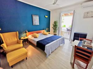 a bedroom with a bed and a chair in a room at Apartments Marija in Supetar