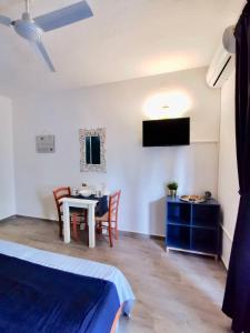 a room with a bed and a table and chairs at Apartments Marija in Supetar