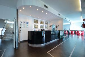 a lobby with a bar in the middle of a building at Hotel Relax Roma Nord in Fiano Romano