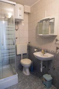 a bathroom with a toilet and a sink and a shower at Apartments Beba in Vir