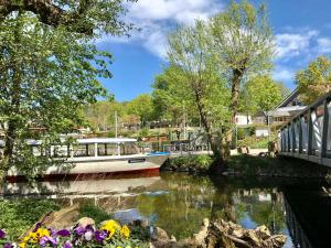 a boat is docked on a river with flowers at Ferienwohnung T _ T 1 in Malente