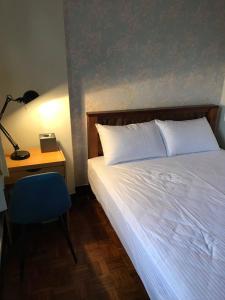 Posteľ alebo postele v izbe v ubytovaní Tainan Yu Pin Ju B&B