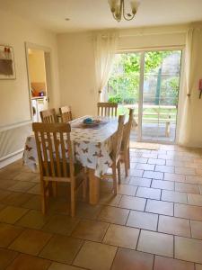 a dining room with a table and chairs and a window at Foxglove House in Valentia Island