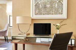 a living room with a table and a lamp at The Gardens Sonesta ES Suites New York in New York