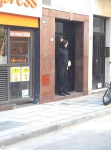 un policier se tenant à l'entrée d'un bâtiment dans l'établissement Amazing Studio Apartment, à Buenos Aires