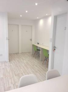 an office with chairs and a table and a desk at Amazing Studio Apartment in Buenos Aires