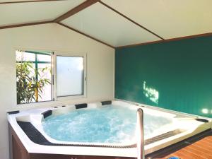 a large bath tub in a room with a window at Caravaning Les Tourterelles in Rang-du-Fliers