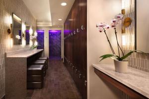 two pictures of a bathroom with a sink and a mirror at Eurostars Magnificent Mile in Chicago