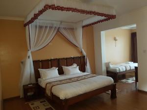 En eller flere senge i et værelse på Esikar Gardens Hotel