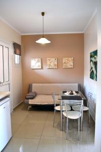 a living room with a couch and a table at Roula Kotsonis Superior Apartment in Argassi +40 photos