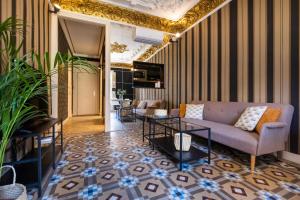 a living room with a couch and a table at eg21- MODERNIST AND ELEGANT APARTMENT IN BCN CITY CENTER in Barcelona