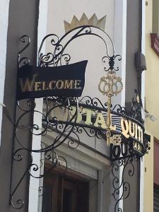 a welcome sign on the side of a building at HOTEL Quito Antiguo in Quito