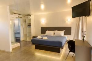 A bed or beds in a room at Undarius Hotel (exclusively gay men)
