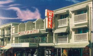 a white building with a mountain hotel on a street at The Moulton Hotel in Hampton