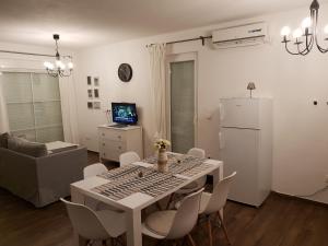 a kitchen and living room with a table and chairs at HIŠA MANDRE in Mandre