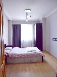 a bedroom with a bed and a large window at tbilisi tower 3 in Tbilisi City
