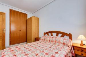ein Schlafzimmer mit einem Bett und einem Holzschrank in der Unterkunft Apartamento Parquemar V in La Mata + 13 Fotos