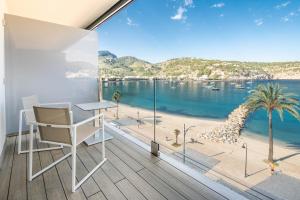 a room with a desk and a view of the ocean at Hotel Eden Soller in Port de Soller