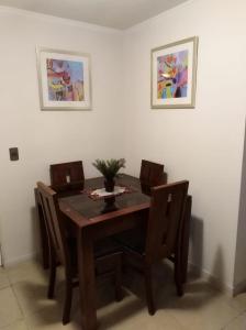 a dining room with a wooden table and chairs at Departamento Marina Sol III in Coquimbo