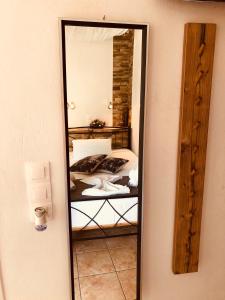 a mirror reflection of a bed in a room at Villa Livadaros in Karterados
