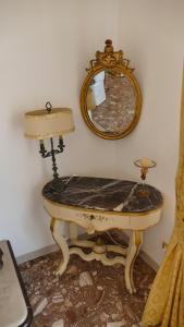 een kaptafel met een spiegel en een lamp bij suite in villa ad Ischia in Ischia