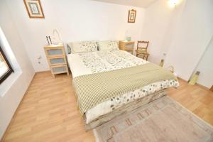 a bedroom with a bed and a wooden floor at Number Nine in Ohrid