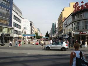 a street with a car on a busy city street at Apartment Abendstern in Berlin