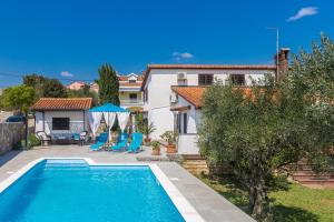 a villa with a swimming pool and a house at Holiday house Ledine -Kornić, Krk in Kornić