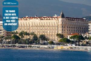 a large building next to a body of water at BLUE CANNES Apartment in Cannes