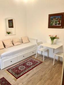 a living room with a white couch and a white rug at Apartments Maria in Ljubljana