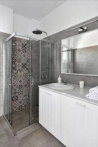 a white bathroom with a shower and a sink at Efi Studios in Drios