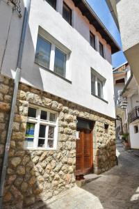 a stone building with two windows and a door at Number Nine in Ohrid