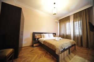 Postel nebo postele na pokoji v ubytování Guest House Batumi Globus