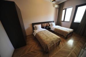 Postel nebo postele na pokoji v ubytování Guest House Batumi Globus