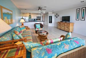 a living room with a couch and a tv at Beachfront At Crystal Cove in East End