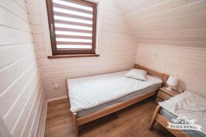 En eller flere senge i et værelse på Białe Domki Mrzeżyno