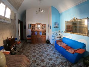 a living room with a blue couch in a room at B&B Favignana in Favignana