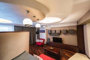 a living room with a couch and a tv at Parliament on Rustaveli Studio in Tbilisi City