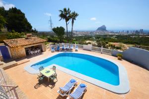 a swimming pool in a villa with a view at Villa Elvira apartamento in Calpe