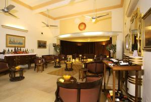 a lobby with chairs and tables and a piano at Karni Bhawan Palace - Heritageby HRH Group of Hotels in Bikaner