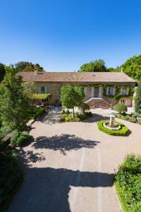 a large house with a driveway in front of it at Moulin de Vaucroze in Sorgues