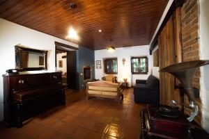 uma sala de estar com um piano e um sofá em Casas do Vale da Rainha em Portimão
