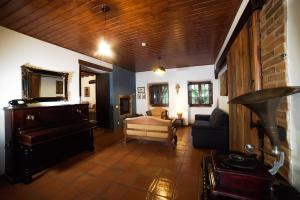 a living room with a piano and a couch at Casas do Vale da Rainha in Portimão +57 photos