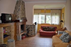 a living room with a couch and a fireplace at Casa en plena naturaleza. in Valdecañas de Tajo