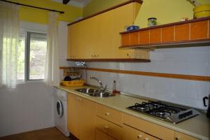 a kitchen with a sink and a stove top oven at Casa en plena naturaleza. in Valdecañas de Tajo