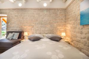 a bedroom with a large bed with two pillows at Olive Garden in Ston