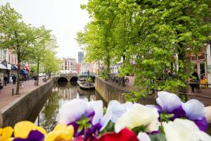 a river filled with lots of flowers next to a bridge at Boutique hotel WKNDS in Leeuwarden