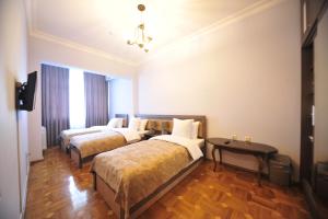 Postel nebo postele na pokoji v ubytování Guest House Batumi Globus