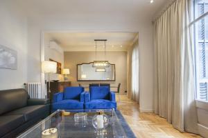 a living room with blue chairs and a blue couch at Tendency Sagrada Familia Luxury in Barcelona