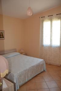 Postel nebo postele na pokoji v ubytování Villa Lu Noto
